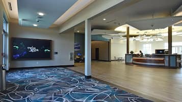 A spacious lobby with a large screen displaying 'Twin River Collection'.