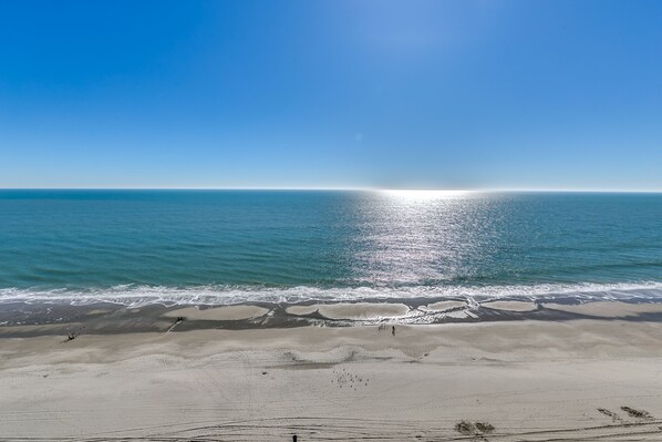 On the beach, sun-loungers