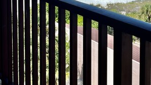 A beach view from a balcony with a railing, clear sky, and calm sea. - Spacious beachfront Penthouse 3 bed/3 bath suite, Stunning Gulf views! (Siesta Key)