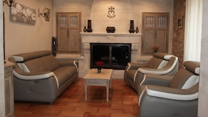 A living room with two sofas, a fireplace, and a coffee table.