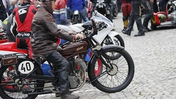 A vintage motorcycle with a number 40 on the back, ridden by a person in a leather jacket.