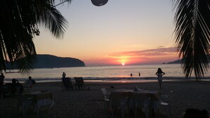 A beachside restaurant with outdoor seating, overlooking the ocean at sunset. - Spectacular luxury penthouse at La Ropa beach, unique view, private rooftop pool (Playa la Ropa)