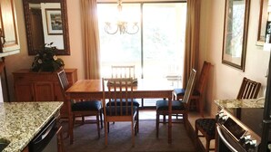 A kitchen with a dining table, chairs, a refrigerator, and a dishwasher. - SEASCAPE SUMMER SPECIAL/Golf Course Villa-2BR/LakeView/PET OK/Short Walk toBeach (Miramar Beach)