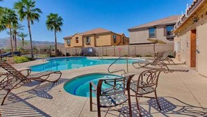 A swimming pool with lounge chairs, a clear sky, and a mountain in the background. - Beautiful 3bd/3ba Phoenix Home near Downtown Area, ASU! (Phoenix)