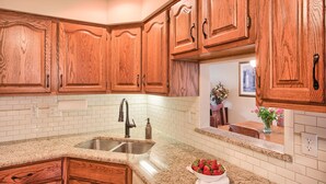A kitchen with wooden cabinets, a granite countertop, and a stainless steel sink. - Home in Mechanicsburg, PA close to  Carlisle, Camp Hill, Enola, Harrisburg area (Mechanicsburg)