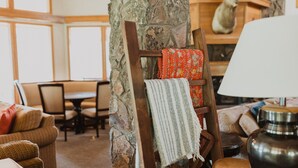 A cozy room with a stone pillar, a wooden ladder, a patterned throw, and a lamp. - The Ultimate Lodge for retreats, family reunions or Destination Weddings (Atlanta)