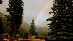 A stone building with a pool, surrounded by tall trees and mountains. - The Ultimate Lodge for retreats, family reunions or Destination Weddings (Atlanta)