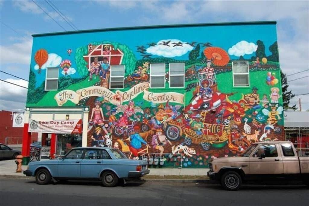 A mural on a building with a sign for "The Community Center."