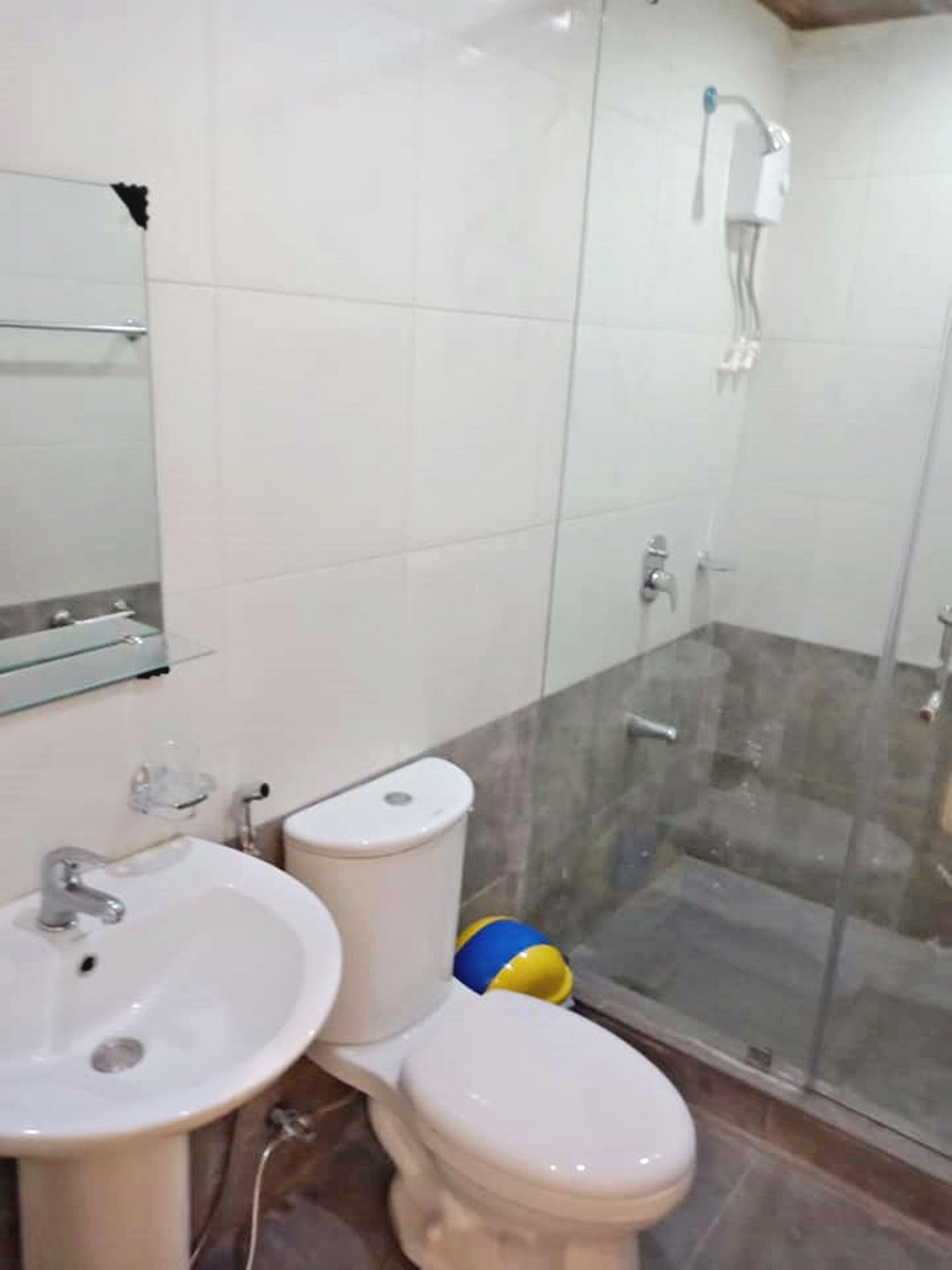 A bathroom with a sink, toilet, and shower.