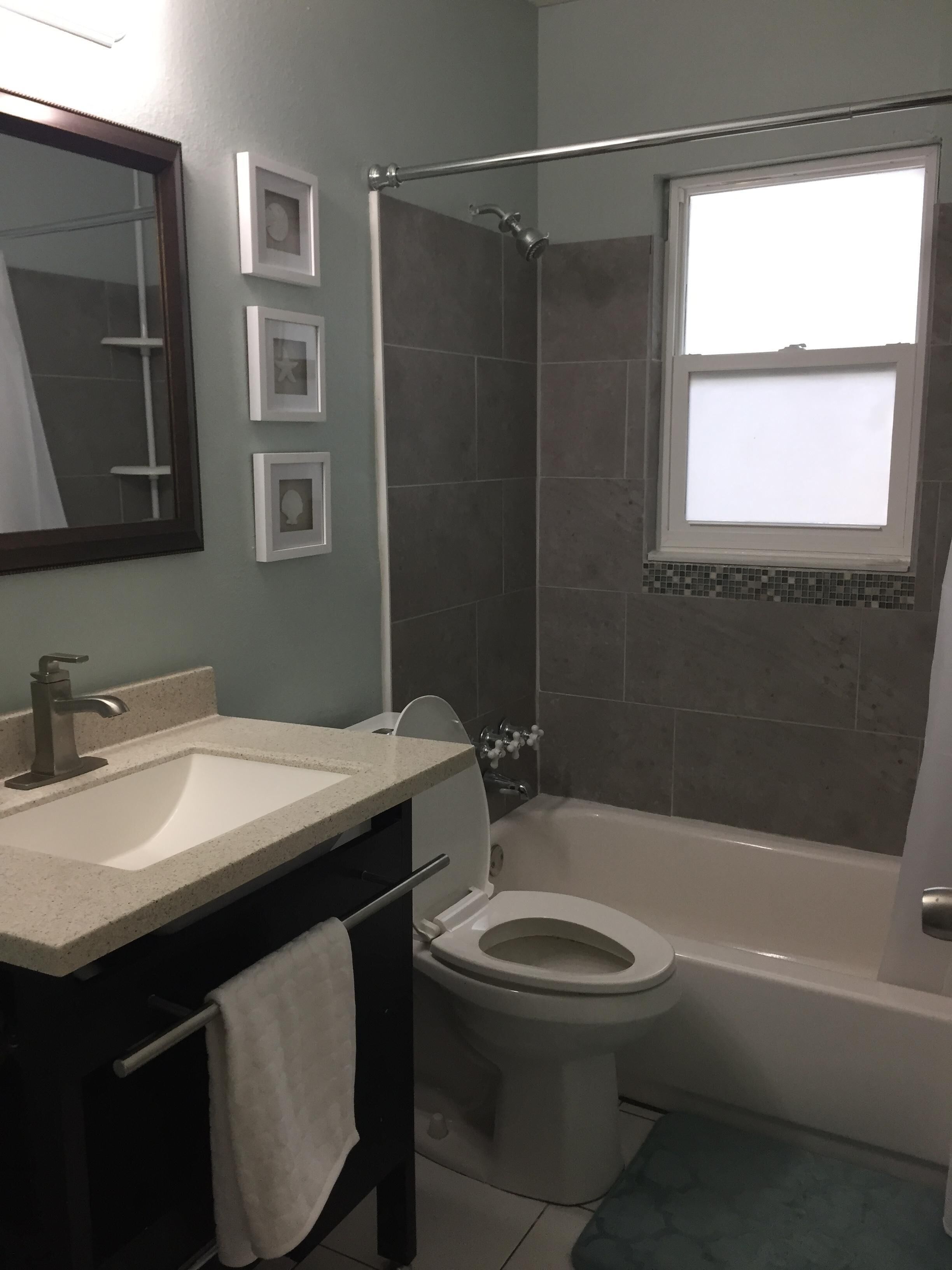 A bathroom with a sink, toilet, and bathtub.