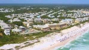 An aerial view of a coastal resort with multiple buildings, a beach, and a view of the ocean. - Sundancer 101-Modern Retreat-Sleeps 6 (Santa Rosa Beach)
