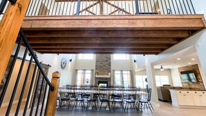 A spacious dining area with a high ceiling and exposed wooden beams. - 10 bedrooms w/Swim/Spa - In/outdoor community pool (Branson)