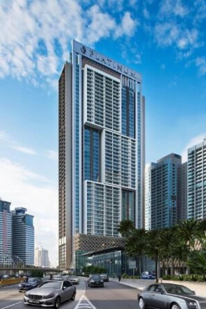 A high-rise hotel with a prominent 'PLATINUM' sign, featuring a modern glass facade and a structured, grid-like window pattern. - Best Homestay (Kuala Lumpur)