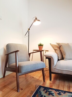 Relax in this inviting space with a plush sofa, comfortable armchair, and natural touches.