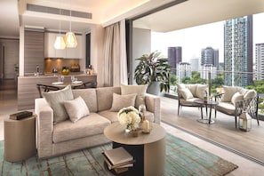 Sala de estar moderna com sofá, mesa de centro e cadeiras. Há uma área de jantar com mesa e cadeiras. Uma janela ampla oferece vista para a paisagem urbana.