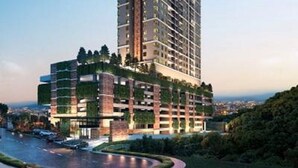 A high-rise building with multiple floors, surrounded by greenery and a curved road. - Gallipoli Anggun Suites (Kuala Lumpur)
