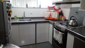 A kitchen with a sink, stove, and cabinets. - THE HOUSE OF JOSE Second Floor  (Cuzco)