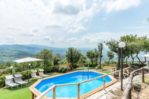 A heated pool, sun loungers