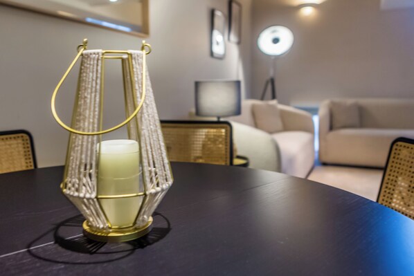 A table with a decorative lantern, a sofa, and a lamp in a living room.