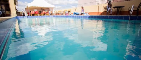 Outdoor pool, a rooftop pool, pool umbrellas