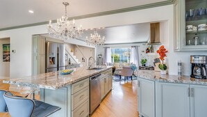 A spacious kitchen with a central island, stainless steel appliances, and a chandelier. - Luxurious, Spacious, Great Views, Minutes to Ocean (Aptos)