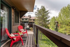 Outdoor seating at one end of the balcony for soaking up the summer sun