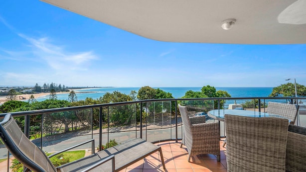 A balcony with a glass railing overlooking a beach and ocean. - Seacrest Unit 4 Moffat Beach QLD (MOFFAT BEACH)