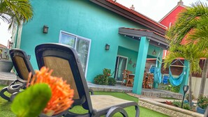 A turquoise building with a patio area featuring outdoor seating and hammocks. - 💕Tranquil Vibe with Your Own Private Pool💕Perfect Location! (Calabas)
