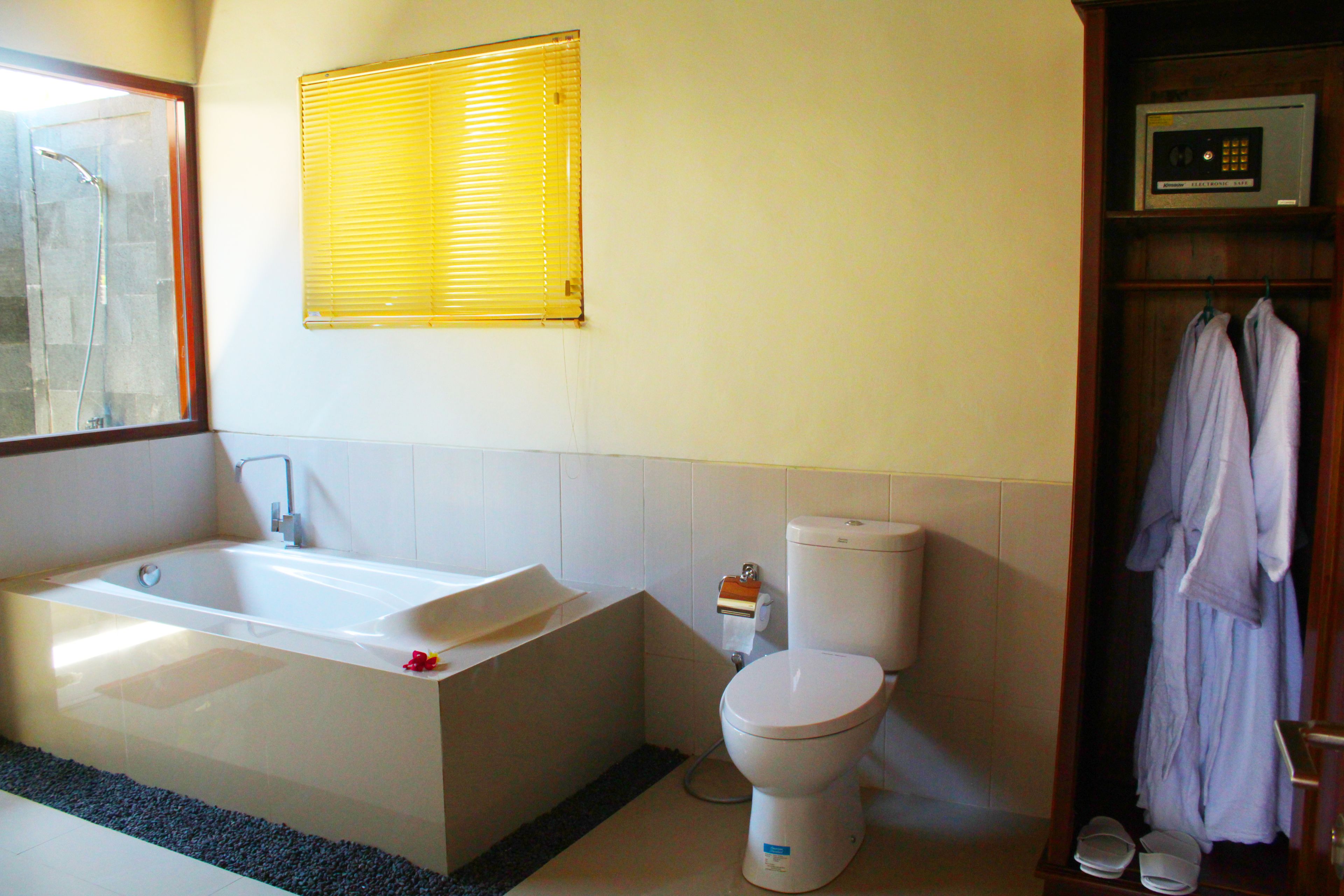 A bathroom with a bathtub, toilet, and a shower.