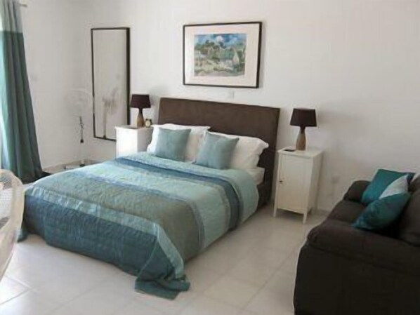 A bedroom with a bed, bedside tables, a nightstand, a painting on the wall, and a window with curtains. - Villa with Private Pool (Yeroskipou)