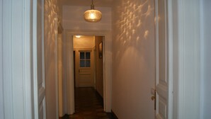 A hallway with a patterned floor, a door at the end, and a light fixture above. - apartment In the heart of Rome wonderful view front of the Colosseum discounts (Roma)