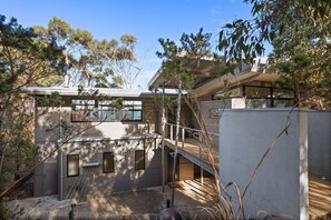 A modern building with multiple windows and a covered outdoor area.