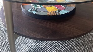 A glass coffee table with a decorative bowl on top, a patterned rug, and a sofa with cushions in a living room. - Beautiful Rehoboth Beach Condo! 3 bed 2 bath! 2 Pools! Tennis! Gym!  (Rehoboth Beach)