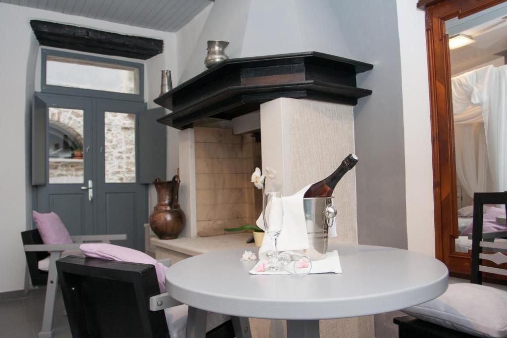 A small round table with a bottle of champagne, a glass, and a napkin.