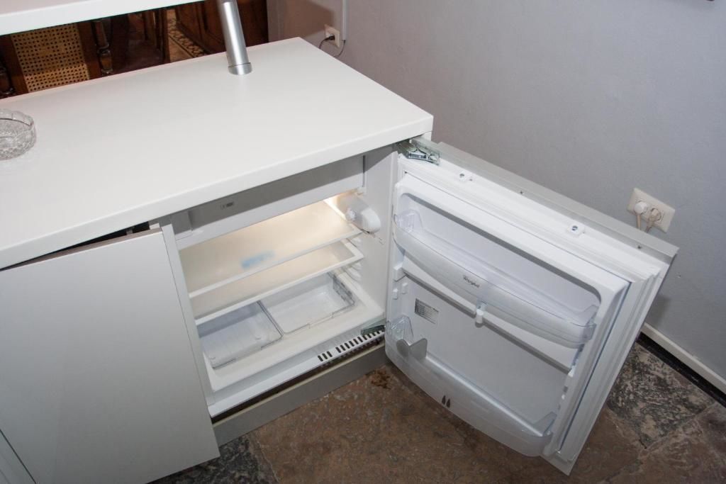 A white refrigerator with a freezer compartment on the left and a main compartment on the right.