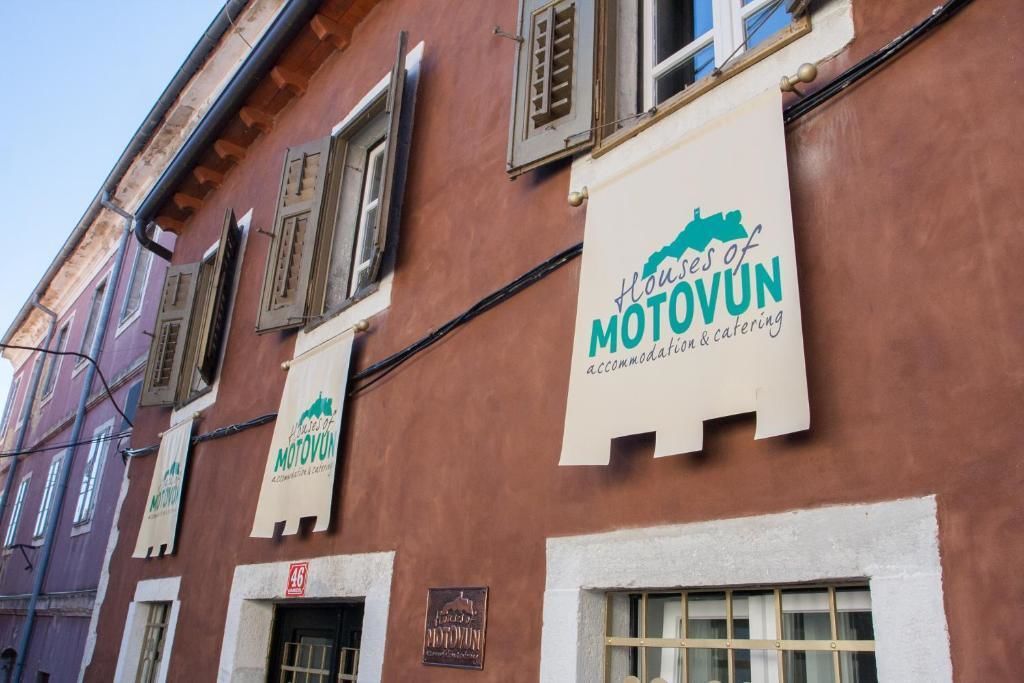A building with multiple banners advertising 'House of Motovun' accommodation and catering.