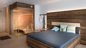 A modern bedroom with a large bed, wooden headboard, and a sauna.
