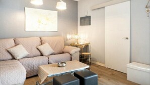 A modern living room with a sofa, a coffee table, and a side table.