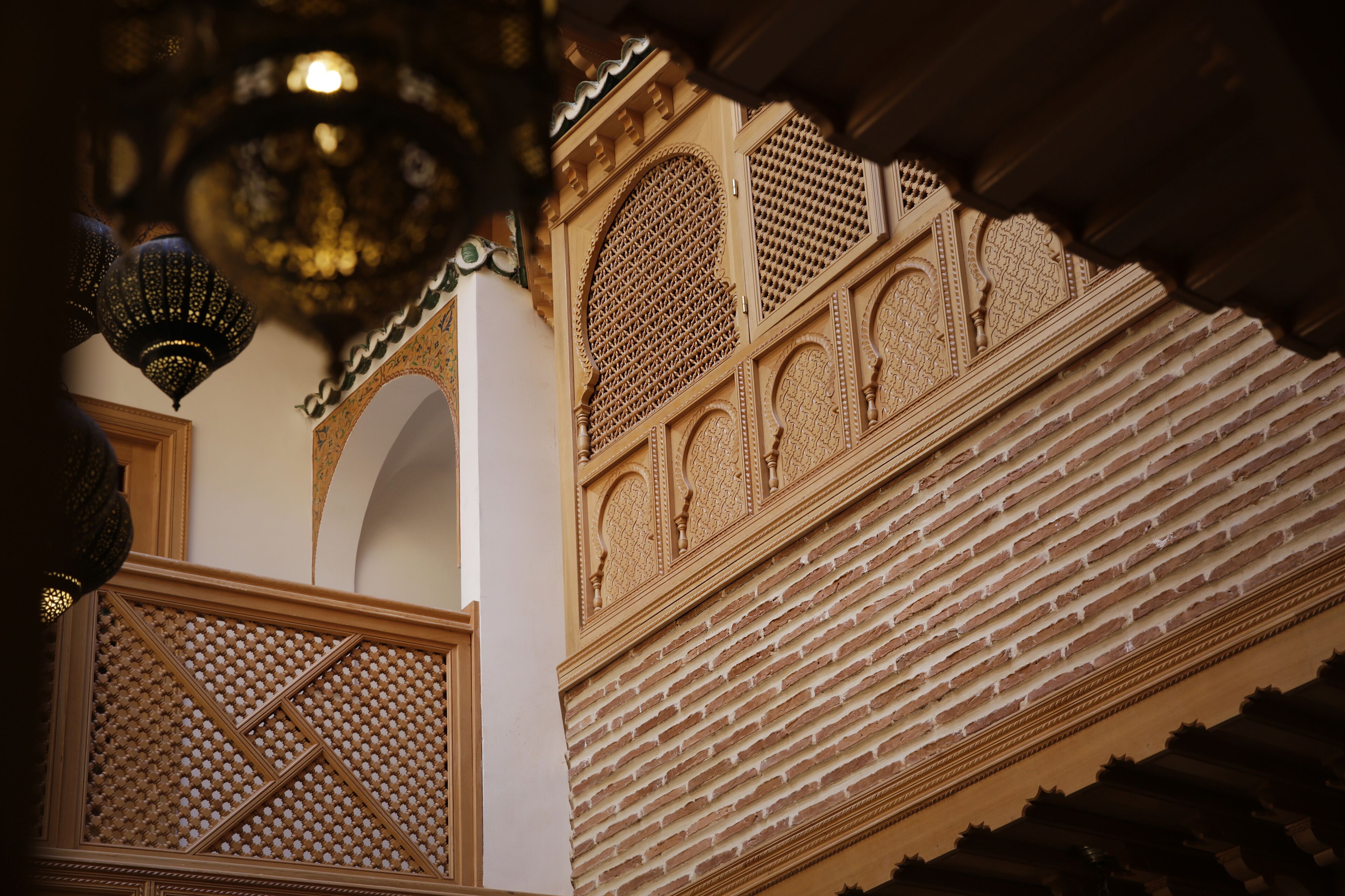 Intricate architectural details with ornate carvings and lattice work on a building facade.