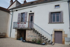Traditional architecture with a stone staircase and wrought iron railings.