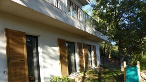 A modern building with a white exterior, large windows with wooden shutters, and a balcony. - CONTEMPORARY VILLA IN PROVENCE CAMPAIGN, AIX EN PROVENCE, AUBAGNE, MARSEILL (Peypin)