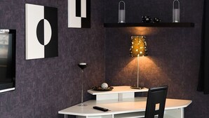 A modern office space with a desk, chair, and a lamp. - Hotel Rosenhof (Isenbuttel)