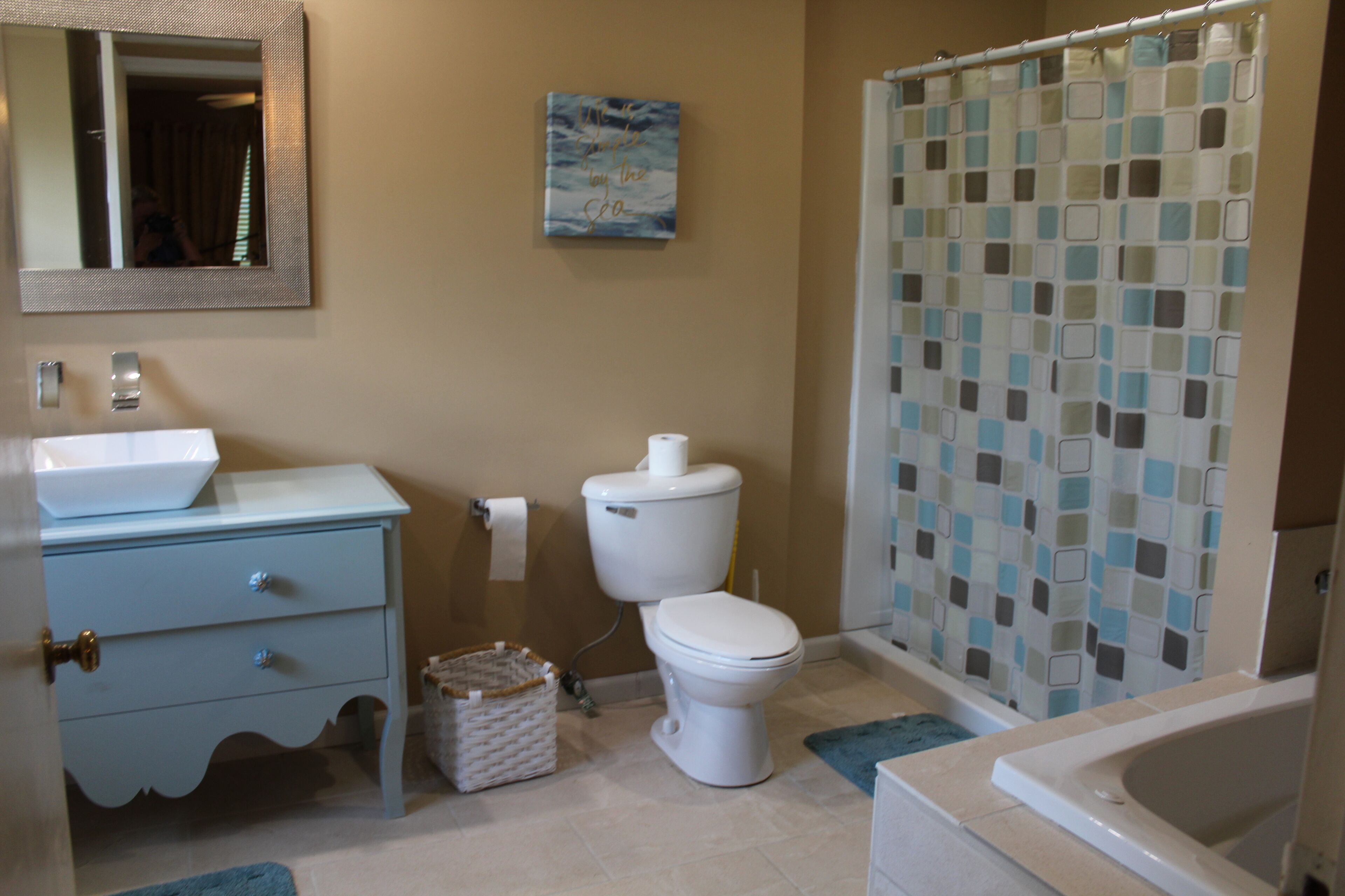 A bathroom with a sink, toilet, and bathtub.