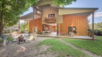 Relax on the spacious patio with comfortable seating and a table, perfect for unwinding or socializing.