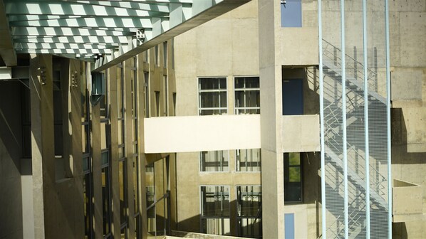 A modern building with a large window and a fire escape. - Bossa Nova Beirut Hotel (Sin El Fil)