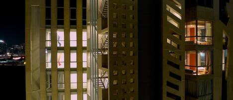 A multi-story building with a series of balconies and windows.