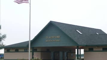 Welcome to the Gladstone Beach House, featuring a covered entrance with a bench and picnic table.