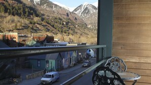 A balcony with a view of a street and mountains. - 'Best Deal in Telluride' - Walk to Gondola & lift 8!     TBL #00111 (Telluride)
