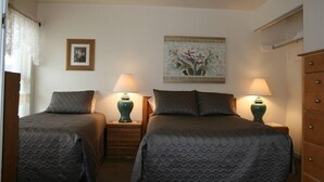 A hotel room with two beds, each with a matching headboard and footboard, flanked by nightstands with lamps. A framed picture hangs on the wall above the beds. - 'Best Deal in Telluride' - Walk to Gondola & lift 8!     TBL #00111 (Telluride)