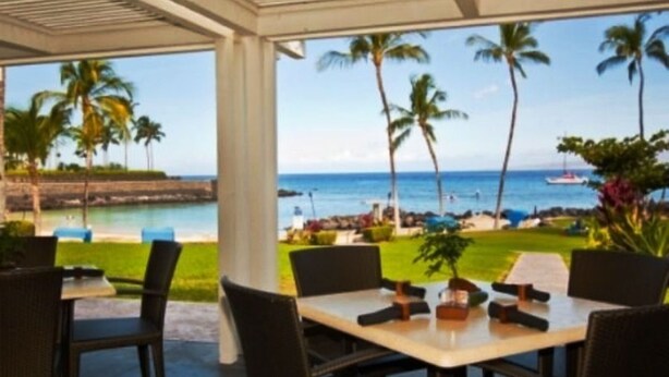 A covered outdoor dining area with a view of the beach and ocean. - Stunning 4  bed, 3 1/2 bath Mauna Lani home near beach, golf (Waimea)